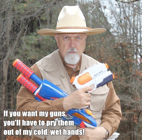 Photo of Dr. Conspiracy holding water pistols