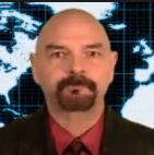 photo of Bob Powell in a suit in front of a world map