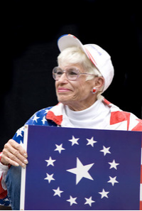 Photo of Barbara Coe holding flag