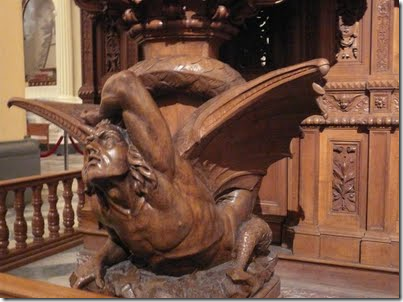 Pulpit detail: Satan crushed by the word of God. Cathedral in Cusco, Peru
