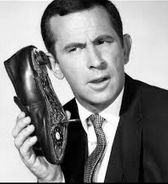 Secret agent Maxwell Smart holding a shoe phone