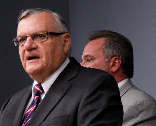Picture of Joe Arpaio with Mike Zullo behind him.