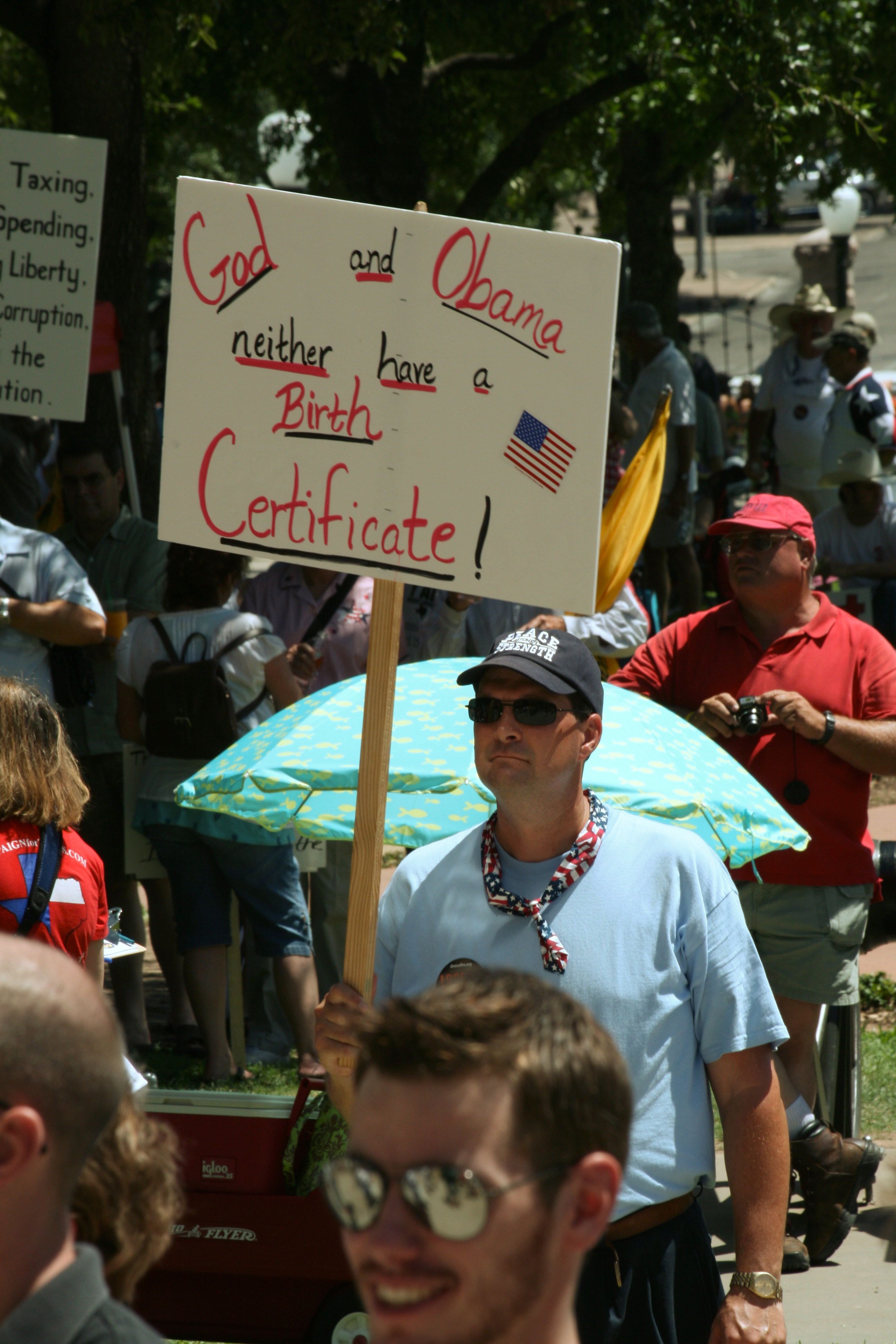 Photo of may carrying sign